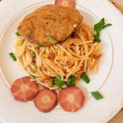 A picture of Orange Sauce Spaghetti with chicken patty.