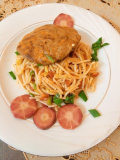 A picture of Orange Sauce Spaghetti with chicken patty.