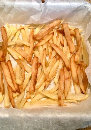 A picture of Pizza with Leftover French Fries.