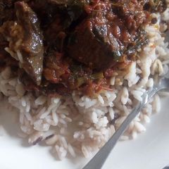 A picture of Rice, beans and red oil stew.
