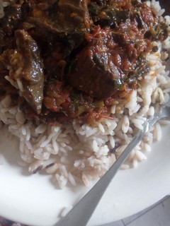 A picture of Rice, beans and red oil stew.