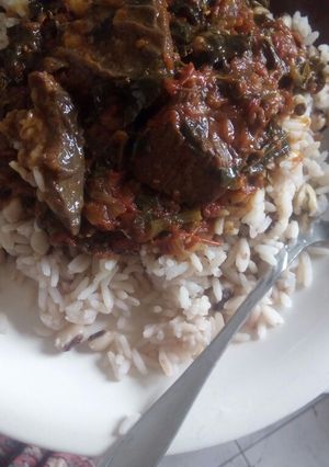 A picture of Rice, beans and red oil stew.