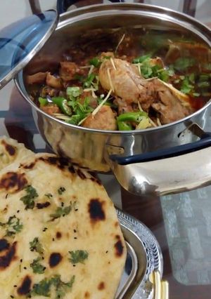 A picture of Chicken karahi with garlic naan (homemade).