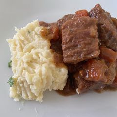 A picture of Beef Stew & Mashed Potatoes with Spring Onion & Chives Cream Cheese.