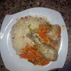 Stirred white rice and chicken sauce A picture of Stirred white rice and chicken sauce.
