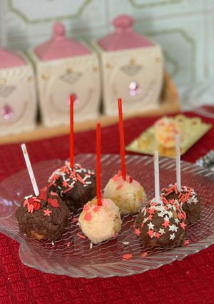 A picture of Chocolate coconut balls with fruit.