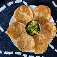 A picture of Aloo Puri with Dry aloo sabzi.