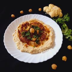 A picture of Grilled Cauliflower with Hummus and Chimichurri.
