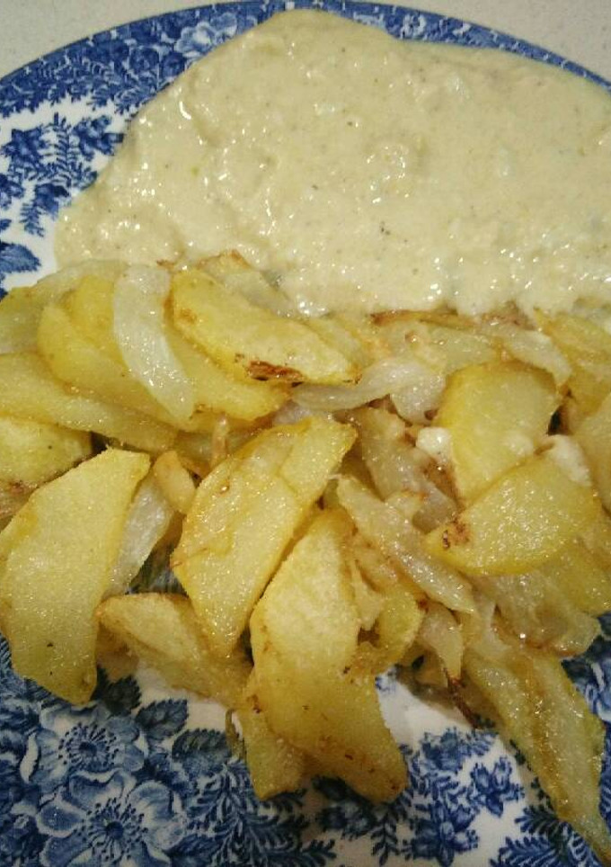 Una foto de Lomo con salsa de queso y patatas encebolladas al ajo