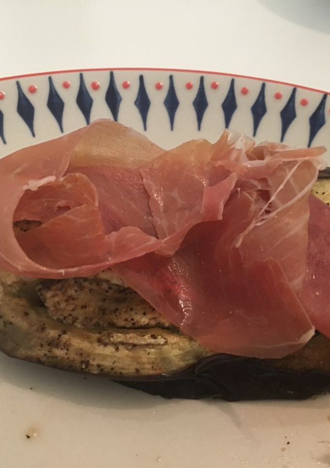 Una foto de Berenjena y tomate asado con jamón serrano