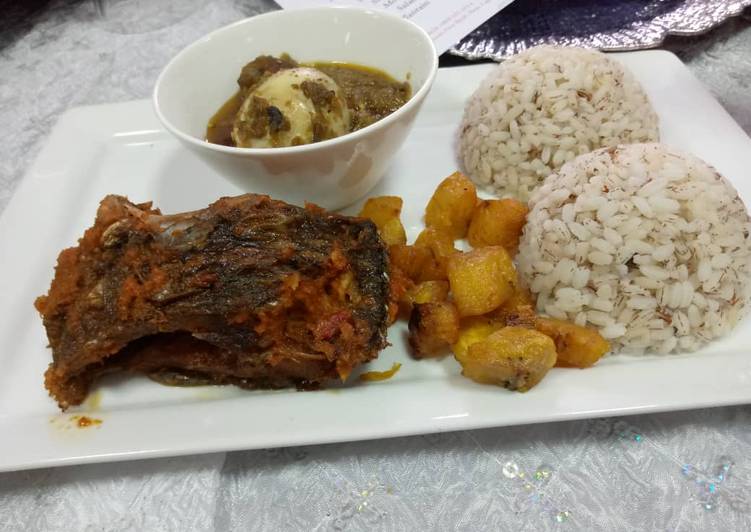 Ofada rice and sauce with fried plantain amd peppered fish