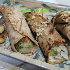 A picture of Oats spring onion paratha  broccoli cheese tikki kathi roll.