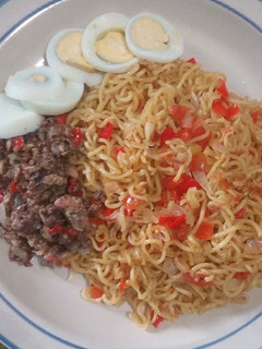 A picture of Tomato Noodles,boiled Egg and Diced fried beef.