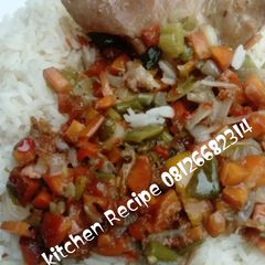 A picture of White rice and chicken sauce.