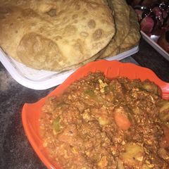 A picture of Fried chappati and vegetable minced meat sauce.