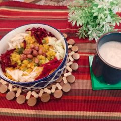 A picture of Vegetable Poha with the goodness of beetroot and cucumber served with almond milk.