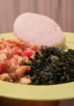A picture of Wet fried eggs, ugali and spinach.