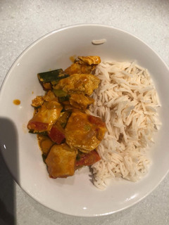 A picture of Chicken sauce and long grain rice.