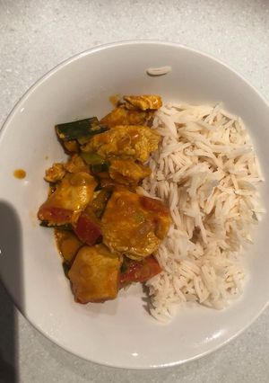 A picture of Chicken sauce and long grain rice.
