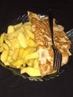 A picture of Fried potatoes with fried egg.
