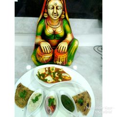 A picture of Paneer butter masala with cucumber curd,green chutney,salad,roti.