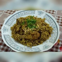 A picture of Chicken Pulao in green masala.