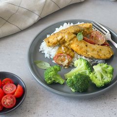 A picture of Saucy Pesto chicken with a side of broccoli.