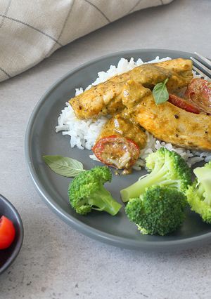 A picture of Saucy Pesto chicken with a side of broccoli.