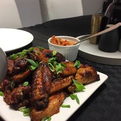 A picture of Buffalo wings with homemade sauce.