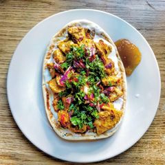 A picture of Coriander Chicken Tikka Masala Pizzas.