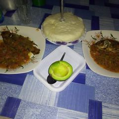 A picture of Fish Stew with Ugali and Avocado.