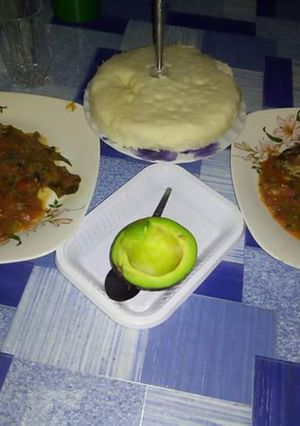 A picture of Fish Stew with Ugali and Avocado.