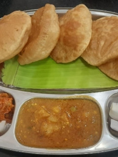 A picture of Puri & aloo subji.