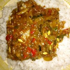 A picture of White rice with cucumber sauce.
