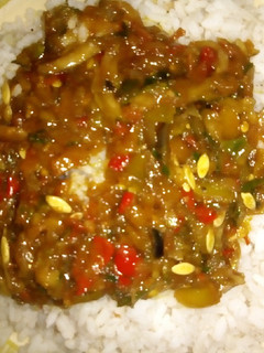 A picture of White rice with cucumber sauce.