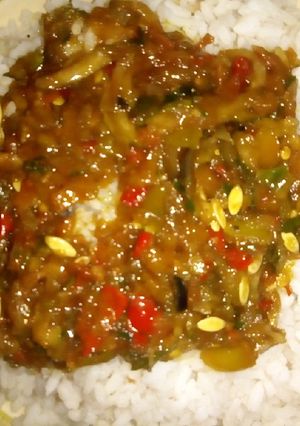 A picture of White rice with cucumber sauce.