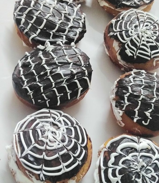 A picture of Donut with vanilla frosting.