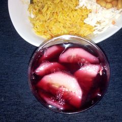 A picture of Plain jollop rice with coleslow and zobo.
