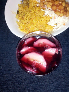 A picture of Plain jollop rice with coleslow and zobo.