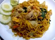 A picture of stir fried chicken and leafy greens