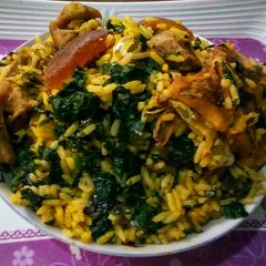 A picture of Palm oil rice and ugu.
