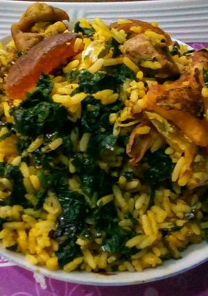 A picture of Palm oil rice and ugu.