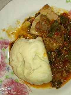A picture of Pounded yam with vegetable soup.