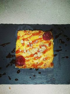 Una foto de Quesada pasiega con salsa de frambuesa, miel y nueces