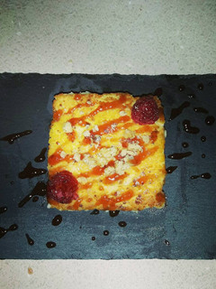 Una foto de Quesada pasiega con salsa de frambuesa, miel y nueces