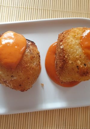 A picture of Potato Bombs Stuffed with Meat and Spicy Sauce.