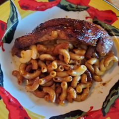 Mac and cheese stuffed brown sugar/cayenne pork chop A picture of Mac and cheese stuffed brown sugar/cayenne pork chop.