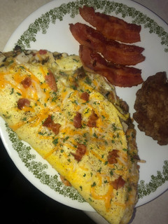 A picture of Smoked turkey, mushroom, bacon & cheese omelette.