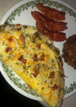 A picture of Smoked turkey, mushroom, bacon & cheese omelette.