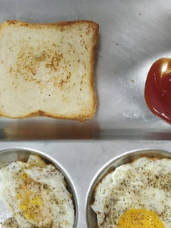 A picture of Bread with half fry Egg.